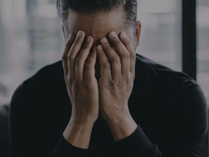 Covering your face with your hands is one way to mask the pain