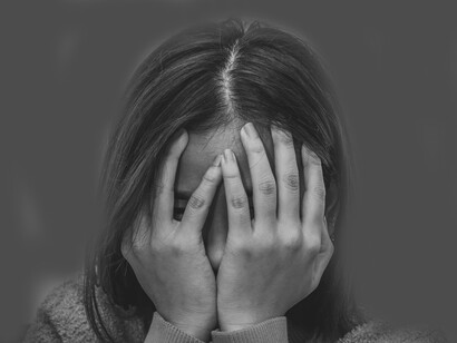 Woman covers her face in shame