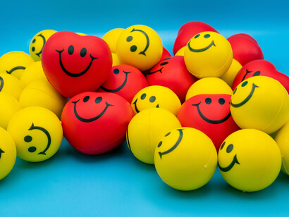 Yellow and red balls with smiley faces signifying happiness