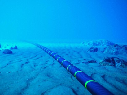 Installation of underwater cables connect power grid systems across continents