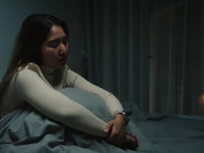 A fearful, desperate woman struggling with depression and anxiety at night