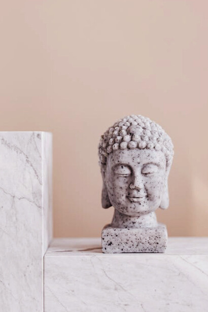 This contemplative bust of Buddha mirrors the Islamic view on suffering, illustrating how faith in God provides inner peace amidst life’s relentless struggles and trials