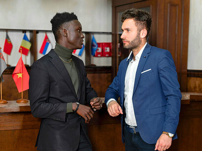 Two representatives locked in careful discussion, reflecting the uncertainty surrounding modern geopolitical alliances