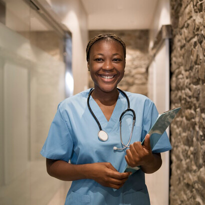 A portrait of a nurse in scrubs at a thoughtfully designed, luxurious clinic