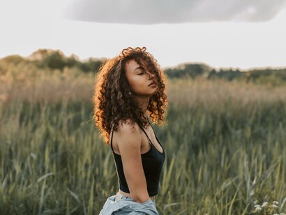 A woman in a field in the evening