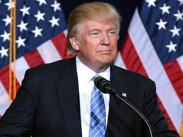 Donald Trump addressing a crowd of supporters during an immigration policy speech at the Phoenix Convention Center in Phoenix, Arizona, USA