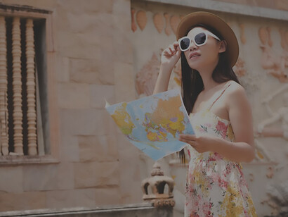 In the heart of the historic old town, a young woman engages with a tourist map, embarking on a cultural journey amidst captivating travel destinations