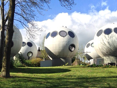 Bolwoningen, a striking example of experimental Dutch architecture, includes 50 spherical homes nestled beside a canal in the Maaspoort neighborhood