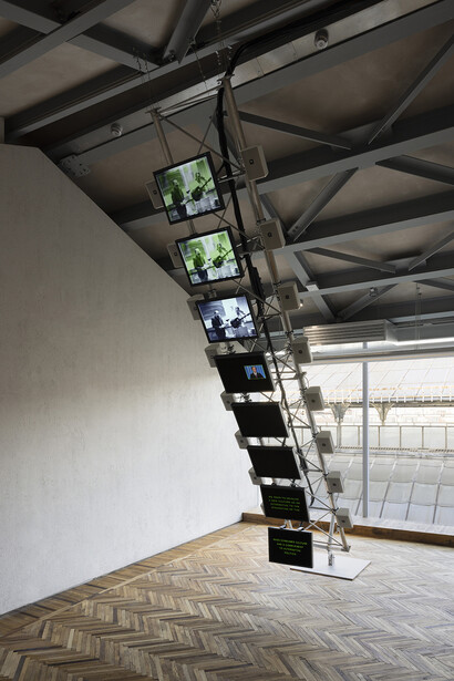 Dara Birnbaum, Transmission Tower: Sentinel, 1992. 8-channel color video, 8-channel stereo audio, 2 sections of Rohn steel transmission tower, plus custom-designed hardware and brackets. Exhibition view “Dara Birnbaum” at Osservatorio Fondazione Prada, Milan, 2023. Courtesy of the artist, Fondazione Prada, Milan, and Marian Goodman Gallery. Photo credit: Andrea Rossetti
