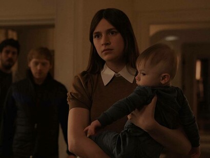 Nell Tiger Free holding a baby in the hit series Servant