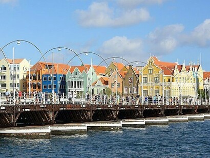 The centuries-old buildings visible here showcase the historic architecture of Curacao, a blend of Dutch Baroque styles with tropical accents