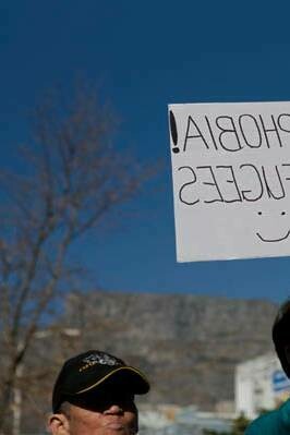 Man attends a gathering in support of refugee rights