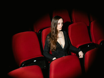 A woman seated in a theatre audience