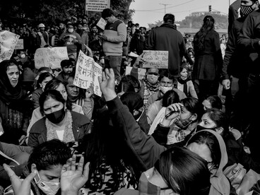 A black-and-white image of women holding banners during a protest, symbolising activism, awareness, and assembly