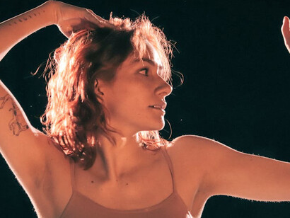 Dancing amidst the blurred lines of time and space, she embodies the soul's journey between light and darkness