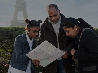 Expat family consulting a map while exploring their new city, highlighting their navigation and adjustment proces