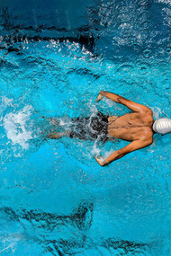 A swimmer gliding through open water, embodying focus and a winning mindset