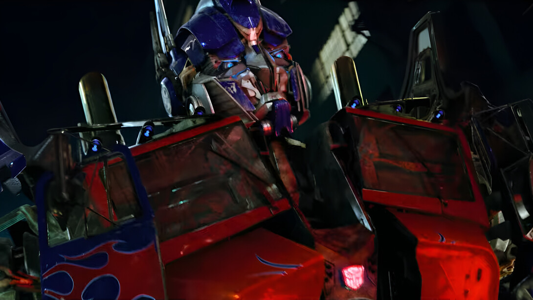 Optimus Prime revealing his imposing robotic form to Sam Witwicky, representing the larger-than-life spectacle and tactile detail of Transformers (2007)