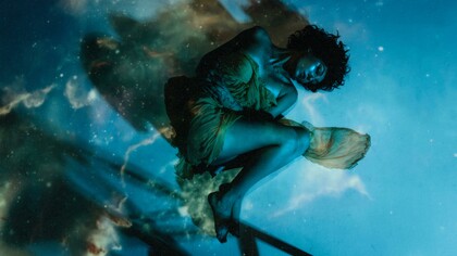 Woman in a dress lying beneath the water’s surface