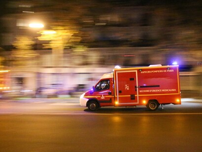 An emergency services vehicle rushes to the Bataclan concert hall. Photograph: Yann Schreiber/Barcroft USA