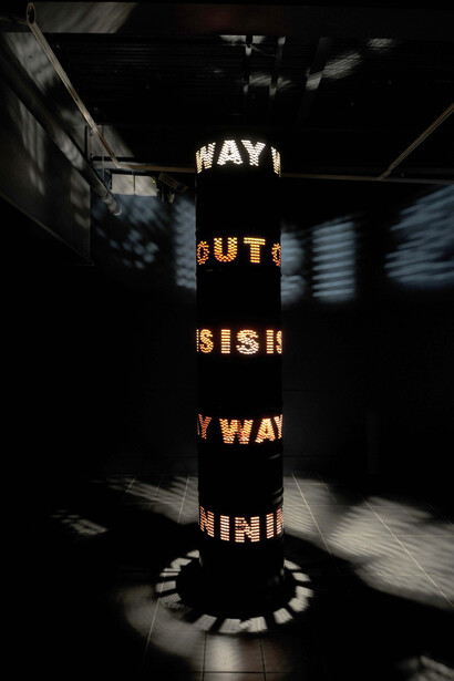 Liliane Lijn, Way Out Is Way In, 2009, Painted steel solvent drums, 3 phase motor, inverter & programmed speed & direction control chip, halogen lighting, 300 x 60cm, Image courtesy the artist