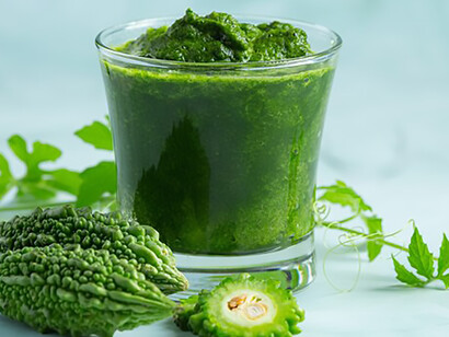 Bitter gourd smoothie served with chopped bitter gourd garnish