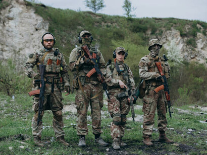 Soldiers in military uniforms, armed with guns and ready for action