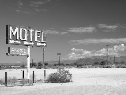 A faded motel sign, marking one of countless pauses along a journey shaped by instinct, curiosity, and open roads