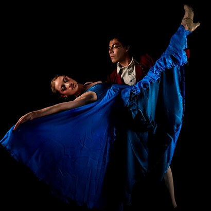 Flamenco dancers in elegant motion, their silhouettes glowing under rich, dramatic light