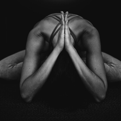 A woman practises yoga on a mat and strengthens her mind, body, and soul
