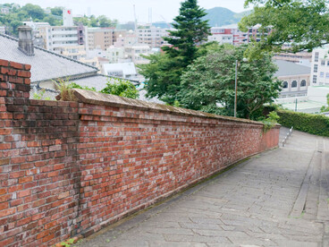 The historic stone-paved Dutch Slope bordered by red brick walls, representing Nagasaki's international heritage