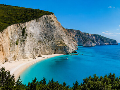 Crystal-clear turquoise waters meet towering white cliffs along the spectacular coastline of Lefkada, Greece