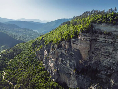 Rock massifs and the Sairme pillars glowing at sunset, seen from above in the Caucasus mountains of Georgia