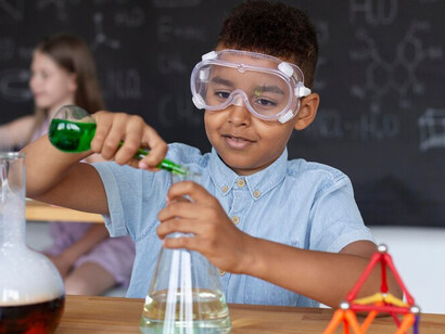 Children experimenting in a lab symbolize the growth of scientific literacy, connecting research with society through active academic outreach
