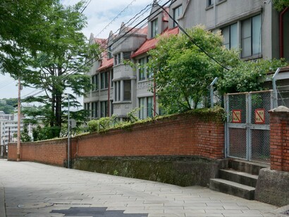 Western-style buildings rising above Dutch Slope's brick walls, reflecting the elegance of Nagasaki's historic district