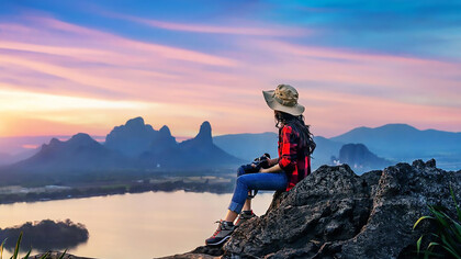 Tourist sitting on Phu sub lek viewpoint at sunset Lopburi Thailand