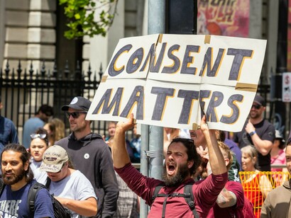 A man holding a sign that says "Consent Matters" during Melbourne's Freedom Protests on November 20, 2021, where over 200,000 people marched from Parliament to Flagstaff Gardens
