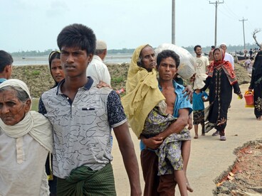 Rohingya refugees crossing the border from Myanmar into Bangladesh