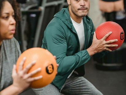 A duo working out with a medicine ball