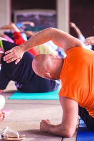 A group of business people practicing yoga as a route to being financially successful