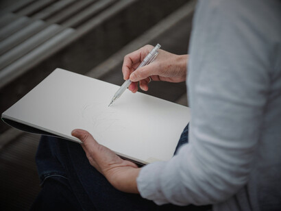 An illustrator sketching, highlighting the role of personal style in creating a studio’s identity