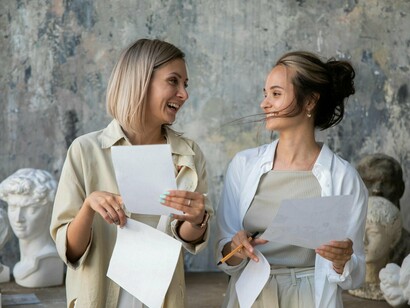Two professionals immersed in artistic work with visible enthusiasm, representing the enduring value of creativity in an automated world
