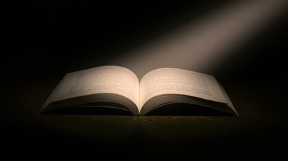 A book in a dark room. Books can provide an understanding of Stoicism and communicate valuable life lessons