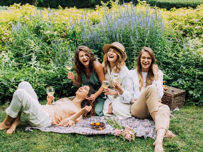 Friends enjoying a glass of white wine together