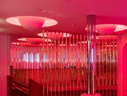 A pinkish hue of a lobby at the Crazy Horse in Paris, France