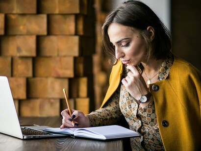 A woman scribbling in her note, symbolizing the moment she realizes love is a choice—and she chooses to write