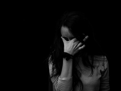 A woman crying, showing effects of anxiety