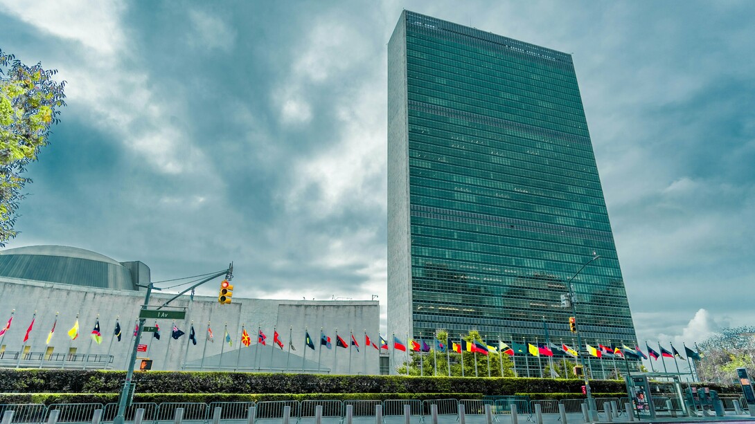 The United Nations Headquarters beneath stormy skies, representing the growing uncertainty surrounding the future of global diplomacy