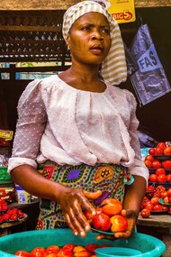 Woman selling tomatoes in a market