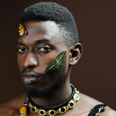 An environmental allegory portraying a topless man and butterflies in peaceful coexistence, reflecting humanity’s fragile yet sacred connection to the natural world